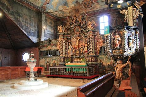 Interiér Dreveného kostola Všetkých svätých s oltárom a maľbami