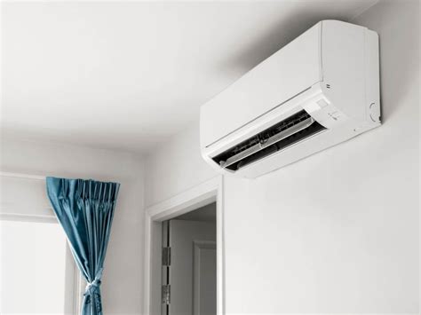 Thematic photo of a modern split air conditioner unit mounted on a wall in a bright room
