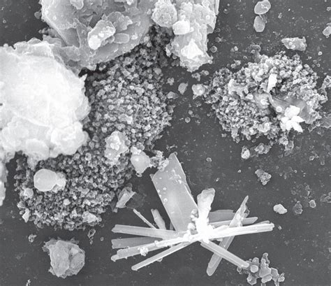 Schéma ionizácie vzduchu: záporné ióny sa viažu na prachové častice a spôsobujú ich usadzovanie